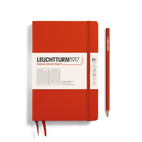 Fox red hardcover ruled notebook with 2 bookmarks, with thin fabric strap closure.